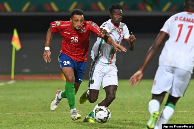 Gambia's defender Ibou Touray (L) is challenged by Mauritania's forward Idrissa Thiam during the Group F Africa Cup of Nations 2021 football match between Mauritania and Gambia at Limbe Omnisport Stadium in Limbe on Jan. 12, 2022.