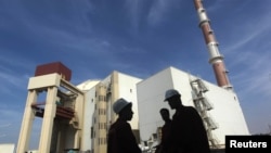 FILE - Iranian workers stand in front of the Bushehr nuclear power plant, about 1,200 kilometers south of Tehran.