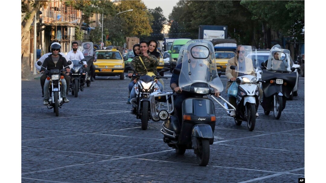 People ride motorcycles in downtown Tehran, Iran, Oct. 8, 2017.