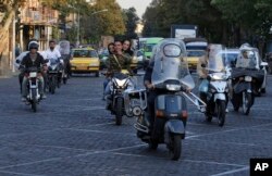 People ride motorcycles in downtown Tehran, Iran, Oct. 8, 2017.