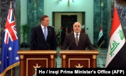 Iraq Prime Minister Haider al-Abadi, right, and his Australian counterpart, Tony Abbott, take part in a press conference in Baghdad, Jan. 4, 2015.