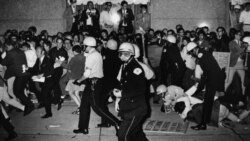 FILE - In this Aug. 29, 1968, file photo, Chicago Police attempt to disperse demonstrators outside the Conrad Hilton, the downtown headquarters for the Democratic National Convention in Chicago.