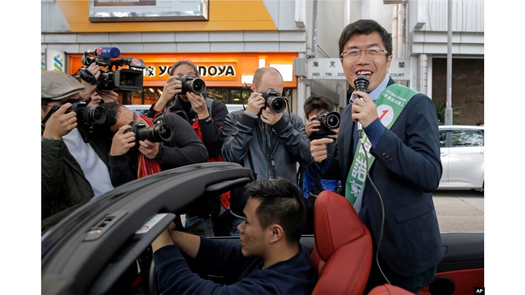 Hong Kong pro-democracy by-election candidate Au Nok-hin, right, speaks during an election campaign in Hong Kong, March 11, 2018.