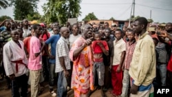 Joseph Bendounga (C), a local opposition leader, speaks to a crowd of people angered by an attack on a church in central Bangui, May 29, 2014.