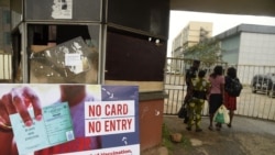 A security official examine workers COVID-19 vaccination passes in Benin City capital of Edo State, southern Nigeria, on Sept. 16, 2021.