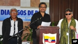 FILE - Ivan Marquez, chief negotiator for the Revolutionary Armed Forces of Colombia (FARC), center, accompanied by Jesus Santrich, right, and Joaquin Gomez, left, speaks at a news conference at the close of another round of peace talks with Colombia's go