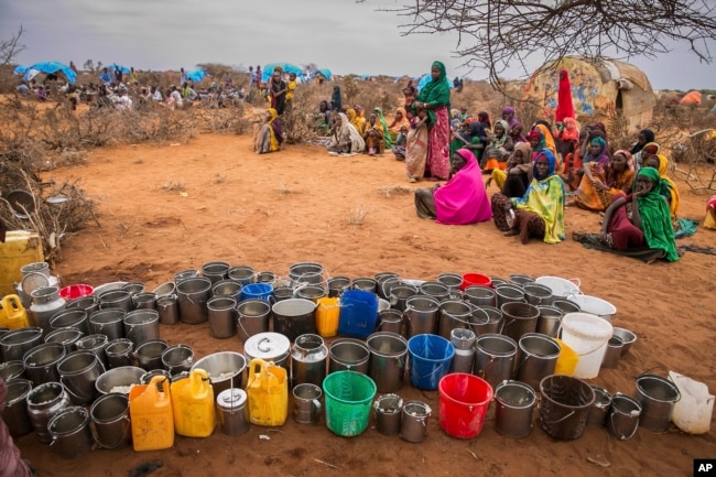 FILE - People wait for food and water in the Warder district in the Somali region of Ethiopia, Jan. 28, 2017. The consumption of contaminated water from shallow wells and ponds meant for cattle, poor nutrition and unsafe hygiene practices have led to outbreaks of cholera and acute watery diarrhea in the impoverished African country.