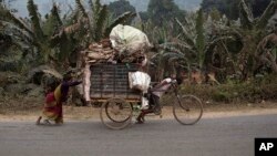 An impoverished Indian family transports recyclable material on a cart on the outskirts of Gauhati, India, Wednesday, Feb. 1, 2017. 