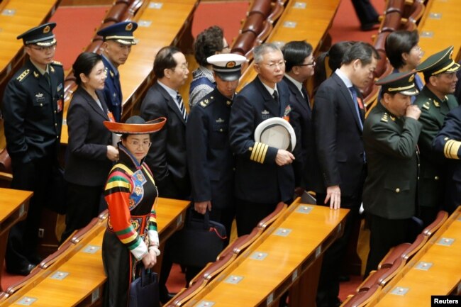 Delegates leave the hall after the second plenary session of the National People's Congress (NPC) at the Great Hall of the People in Beijing, March 8, 2019.