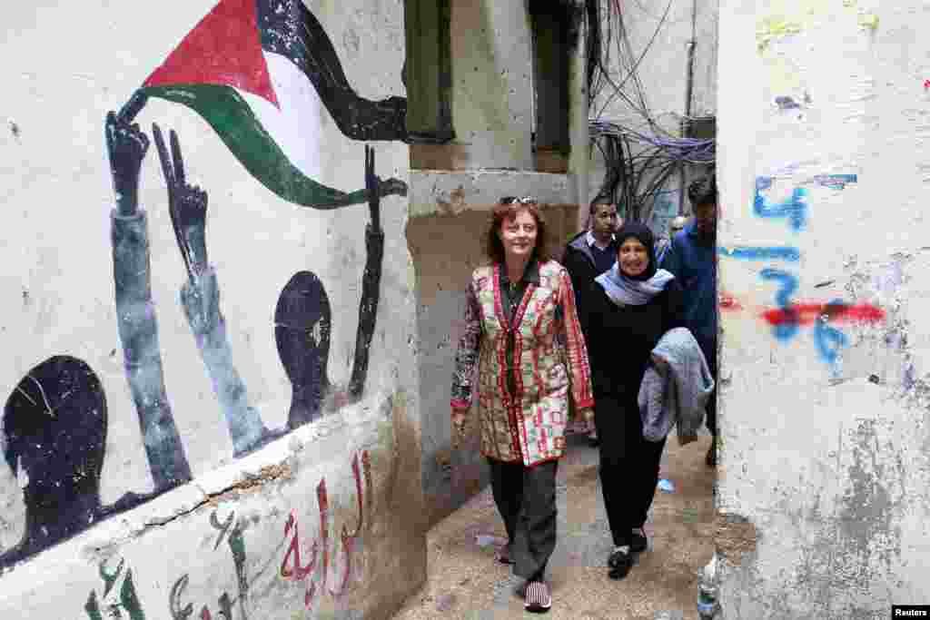 Hollywood actress and social activist Susan Sarandon walks with Mariam Shaar, a Palestinian entrepreneur in Burj al-Barajneh refugee camp in Beirut, Lebanon.