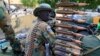 FILE - A South Sudan army soldier stands next to a machine gun mounted on a truck in Malakal town, some 500 km (312 miles) northeast of the capital, Juba.