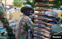 FILE - A South Sudan army soldier stands next to a machine gun mounted on a truck in Malakal town, some 500 km (312 miles) northeast of the capital, Juba.