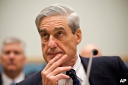 FILE - Then-FBI Director Robert Mueller listens as he testifies on Capitol Hill in Washington, June 13, 2013.