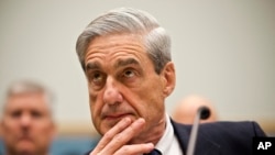 FILE - Robert Mueller, then the FBI director, listens as he testifies on Capitol Hill in Washington, June 13, 2013. 