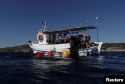 Volunteers of the environmental group Aegean Rebreath bring ghost nets from the bottom of the sea on their boat, off the island of Salamina, Greece, June 30, 2019. Picture taken June 30, 2019. REUTERS/Stelios Misinas
