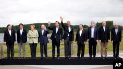 FILE - Leaders pose during a group photo opportunity during the G8 summit at the Lough Erne golf resort in Enniskillen, Northern Ireland, on June 18, 2013. This year's G8 Summit will be hosted by Vladimir Putin in Sochi, Russia June 4-5. 