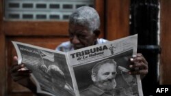 A man reads a newspaper in a street of Havana two days after Cuban revolutionary leader Fidel Castro died.
