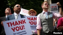 Members of the London Gay Men's Choir perform in front of the Houses of Parliament in central London on July 15, 2013. Their vigil and performances were timed to coincide with the Marriage Bill being read in the House of Lords.