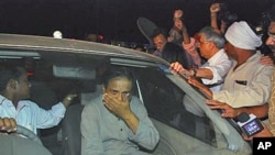 Jailed Indian doctor and human rights activist Binayak Sen, center, is mobbed by his family and supporters as he sits in a car after his release from the prison in Raipur, Chattisgarh state, India, April 18, 2011
