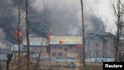 A house where suspected militants were holding up is seen in flames during a gun battle with Indian security forces in Pinglan village in south Kashmir's Pulwama district, Feb. 18, 2019.