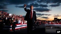 President Donald Trump pumps his fist to the crowd after speaking to a campaign rally in Montoursville, Pa., May 21, 2019. 