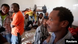 FILE - African migrants are seen in their dormitory at a detention center in Sorman, 55 km (34 miles) west of Tripoli, Libya.