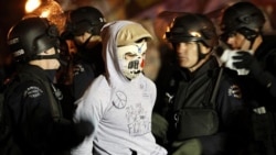 Police arrest an Occupy LA protester at the encampment cleared during a raid by 1,400 officers at Los Angeles City Hall