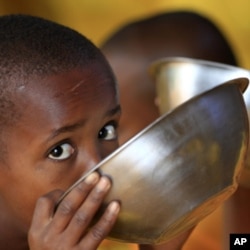 Somali refugee boys eat porridge during break time at the Liban integrated academy at the Ifo refugee camp in Dadaab.