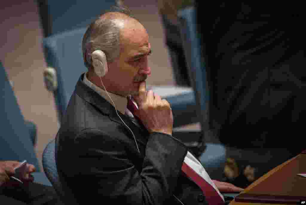 Syria&#39;s permanent representative to the United Nations Bashar Ja&#39;afari listens before a Security Council vote to support a resolution endorsing a cease-fire in Syria, Feb. 26, 2016 at United Nations headquarters.