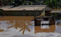 A house is seen at a flooded area after pouring rains in Mario Campos, in Minas Gerais state, Brazil, Jan. 12, 2022.