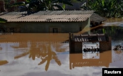 A house is seen at a flooded area after pouring rains in Mario Campos, in Minas Gerais state, Brazil, Jan. 12, 2022.