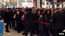 Shoppers line up to get on the escalator at Mac's Herald Square on Thanksgiving, Nov. 28, 2013. (Photo Sandra Lemaire)