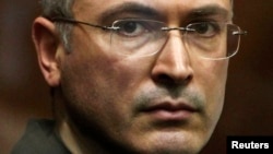 FILE - Jailed Russian former oil tycoon Mikhail Khodorkovsky stands in the defendants' cage during a court session in Moscow in 2010.