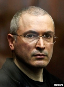 FILE - Russian former oil tycoon Mikhail Khodorkovsky stands in the defendants' cage during a court session in Moscow in 2010.