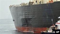 In this photo released by the Emirates News Agency (WAM), damage is seen on the side of the 'M. Star' oil supertanker offshore Fujairah port in the United Arab Emirates. The AAB has claimed responsibility for last year’s bombing.