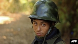 FILE - A Kachin rebel stands guard on Hka Ya mountain in Kachin province, Myanmar, Jan. 20, 2013.