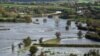 FILE - Fields are covered in floodwater after Storm Callum passed through the town of Carmarthen, west Wales, Britain, Oct. 14, 2018.