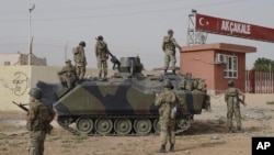 Turkish military station at the border gate with Syria, across from Syrian rebel-controlled Tel Abyad town, in Akcakale, Turkey, October 7, 2012. 
