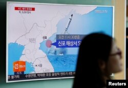 FILE - A passenger walks past a TV screen at a railway station in Seoul, South Korea, broadcasting a news report on North Korea's submarine-launched ballistic missile fired from North Korea's east coast port of Sinpo July 9, 2016. REUTERS/Kim Hong-Ji