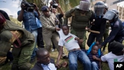 Sejumlah protester atas UU Keamanan Kenya yang kontroversial, ditangkap dan dipukuli dengan kayu oleh polisi di luar gedung parlemen Kenya (18/12/2014).