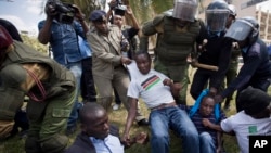FILE - Protesters rallying against Kenya's new security law are detained by police outside the parliament building in Nairobi, Dec. 18, 2014.