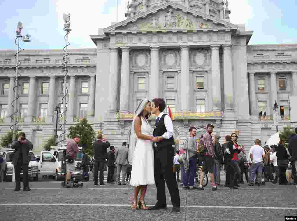 Lisa Dazols (R) and Jenny Chang celebrate after the U.S. Supreme Court ruled on California&#39;s Proposition 8 and the federal Defense of Marriage Act, outside the city hall in San Francisco, California. The U.S. Supreme Court handed a significant victory to gay rights advocates by recognizing that married gay men and women are eligible for federal benefits and paving the way for same-sex marriage in California.
