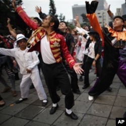 Thousands of people perform at the Monument of the Revolution in Mexico City, during an attempt to break the Guinness World Record of people dancing Michael Jackson's Thriller, in 2009. The event was organized in honor of the late pop star's birthday.