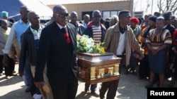 Mourners carry the casket of Andries Motlapula Ntsenyeho, one of the 34 striking platinum mineworkers shot dead at Lonmin's Marikana mine, in his hometown of Sasolburg in South Africa's Free State province, September 1, 2012.