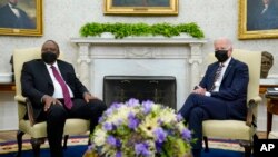 President Joe Biden, right, meets with Kenyan President Uhuru Kenyatta, left, in the Oval Office of the White House in Washington, Oct. 14, 2021.