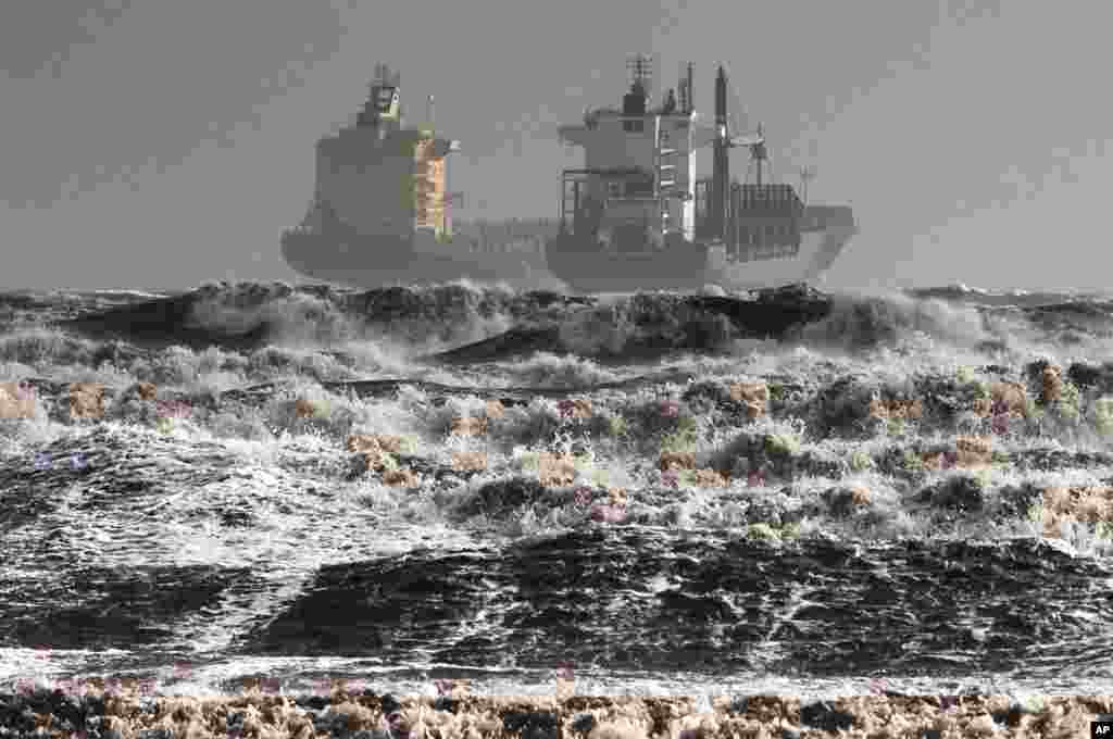 Two tankers are battered by gale winds in the rough waters of the Gulf of Cagliari, Sardinia, Italy, Nov. 18, 2013.