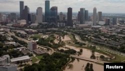 The Houston skyline is seen in the background as Buffalo Bayou is floods from Tropical Storm Harvey in Texas, Aug. 30, 2017. 