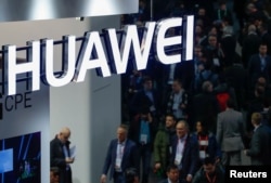 FILE - A logo of Huawei is seen during the Mobile World Congress in Barcelona, Spain.