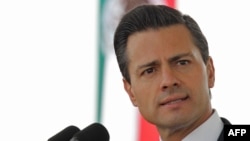 FILE- Mexican President Enrique Pena Nieto speaks during the ceremony of the National Flag day in Frontera city, Coahuila state, Mexico, Feb. 24, 2014. (Photo credit: Presidencia / Julio Cesar Hernandez / Handout) 