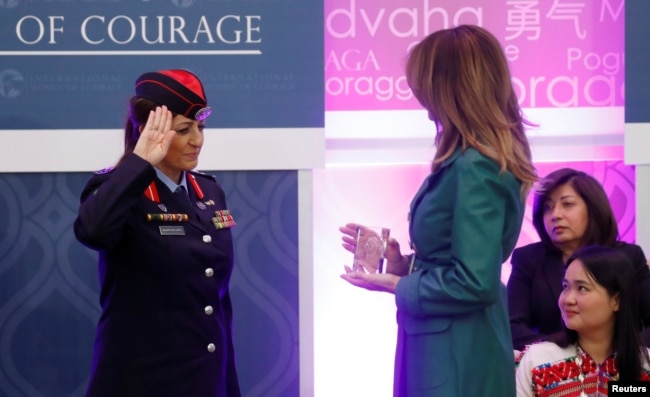 First lady Melania Trump receives a salute as she presents an award to Jordanian police officer Colonel Khalida Khalaf Hanna al-Twal during the International Women of Courage (IWOC) celebration at the State Department in Washington, U.S., March 7, 2019.